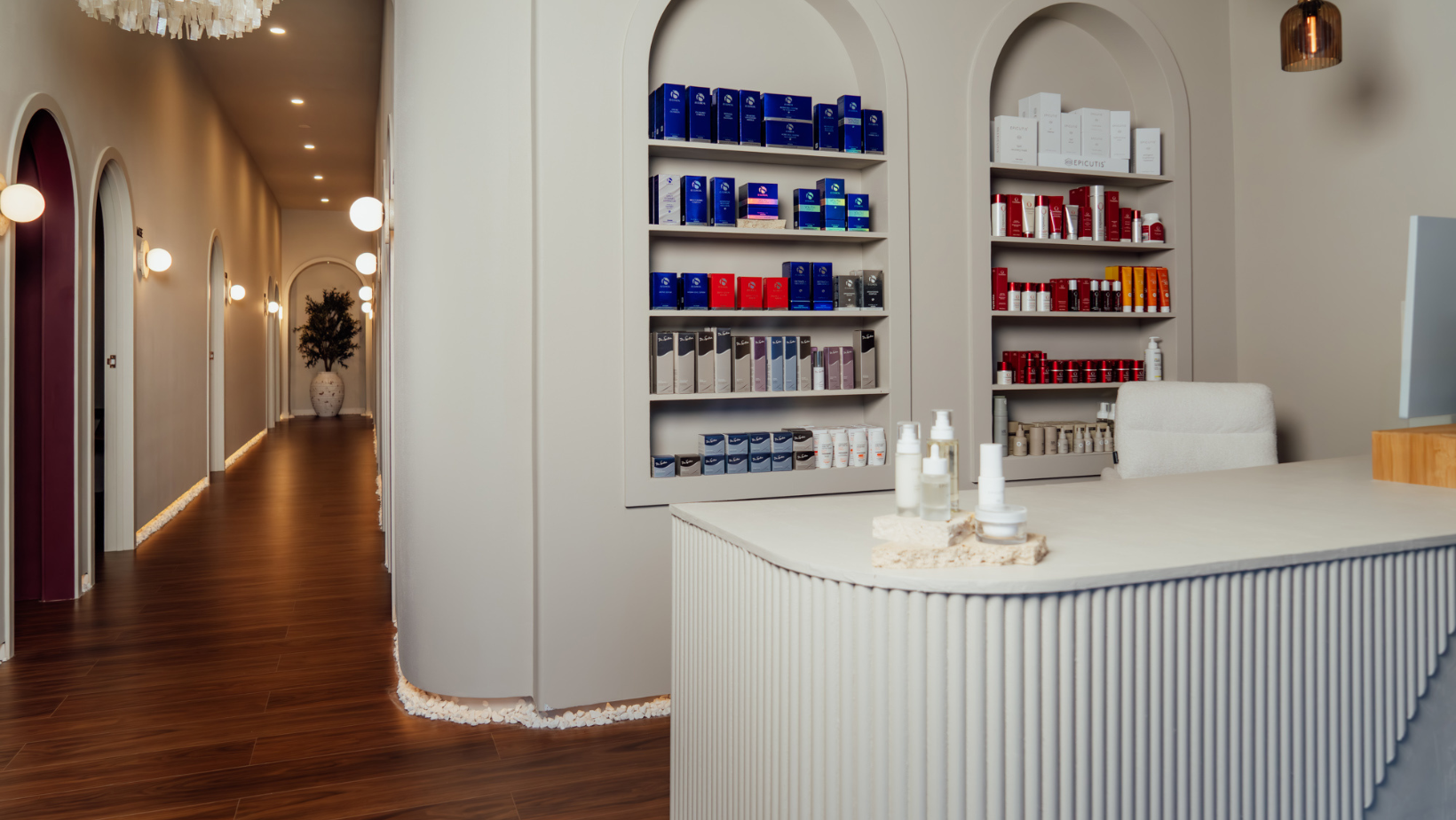 Modern interior of a pharmacy with shelves stocked with medications and a reception desk.